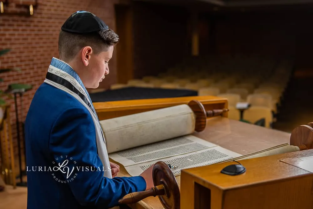 Bar mitzvah boy at the bimah with the Torah