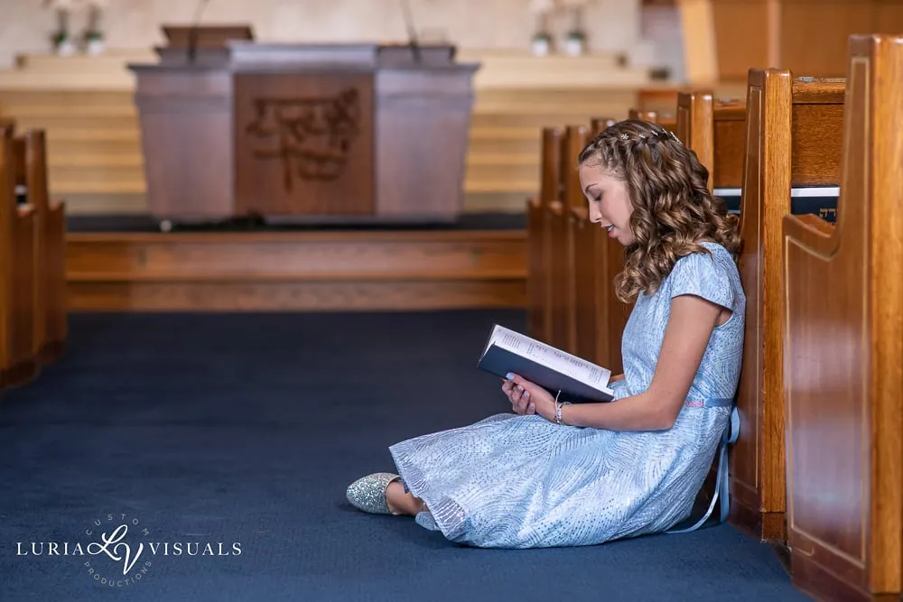 Bat mitzvah girl reading quietly in the sanctuary