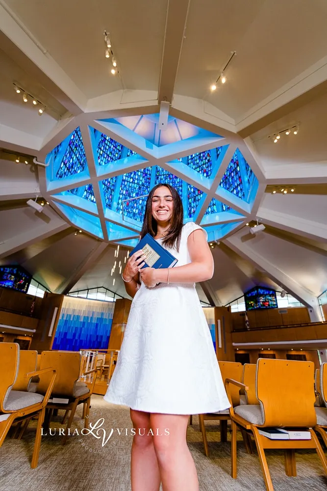 Bat mitzvah girl beneath a stained glass Star of David
