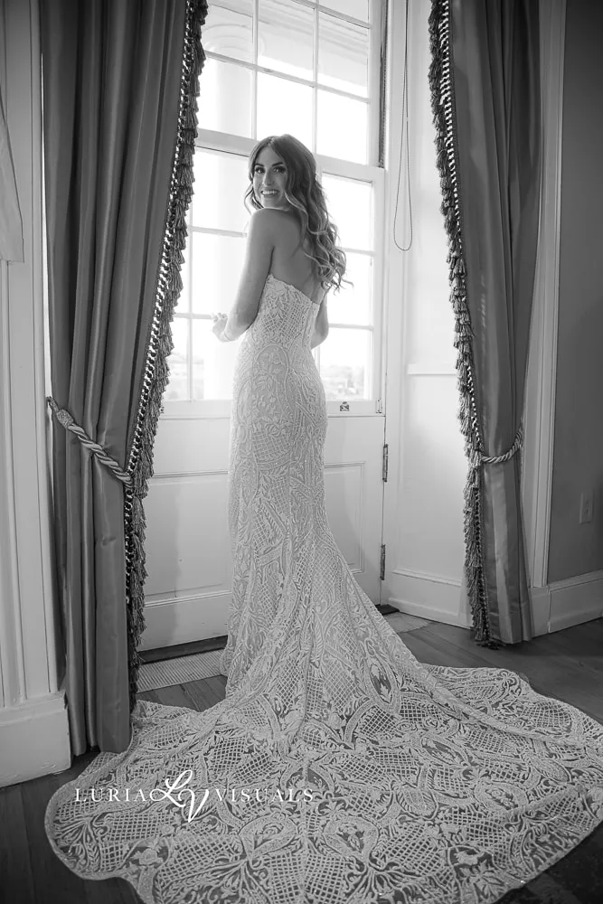 Bride at a tall window, black and white