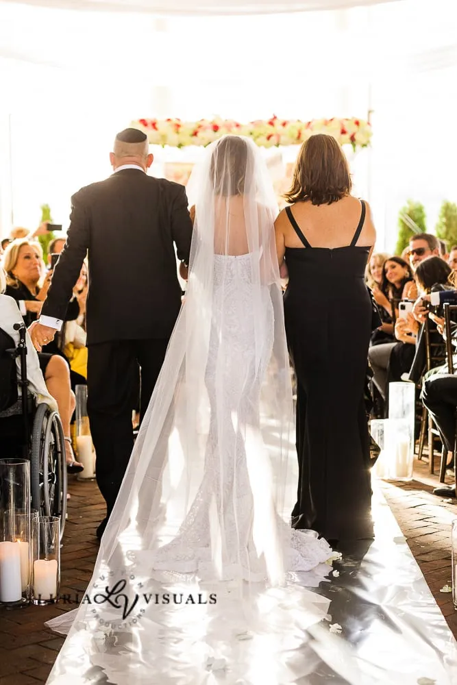 Bride walking down the aisle with her parents